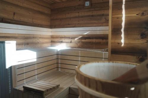 a bathroom with a tub in a wooden room at Zugspitz Lodge in Ehrwald