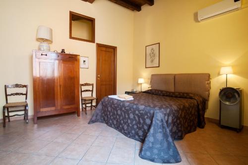 a bedroom with a bed and a table and chairs at VinsLounge Suite in Barletta