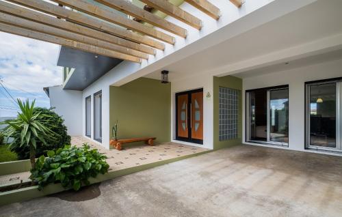 an indoor patio with a wooden ceiling and large windows at Azores Mountain View in Ribeira Grande