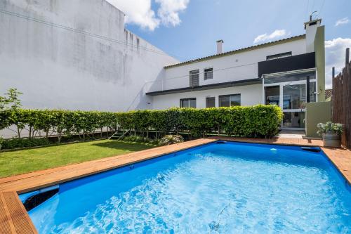 a swimming pool in the backyard of a house at Azores Mountain View in Ribeira Grande