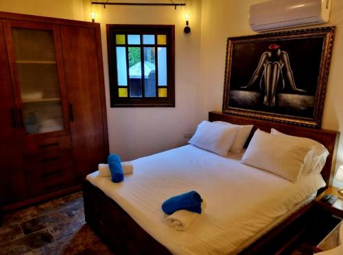 a bedroom with a bed with two hats on it at The Pearl of the Golan - Pnina BaGolan in Had Nes