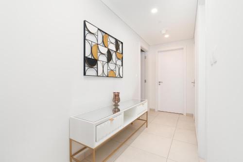 a white room with a white console and a stained glass window at Ultimate Stay / Burj Al Arab View / Brand New / Amazing Pool with a View / Perfect Holiday / Madinat Jumeirah / 2 BDR in Dubai