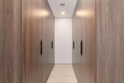 a hallway with two wooden doors in a building at Ultimate Stay / Burj Al Arab View / Brand New / Amazing Pool with a View / Perfect Holiday / Madinat Jumeirah / 2 BDR in Dubai
