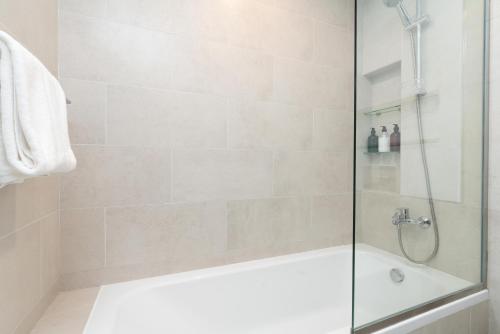 a bathroom with a shower with a bath tub at Ultimate Stay / Burj Al Arab View / Brand New / Amazing Pool with a View / Perfect Holiday / Madinat Jumeirah / 2 BDR in Dubai