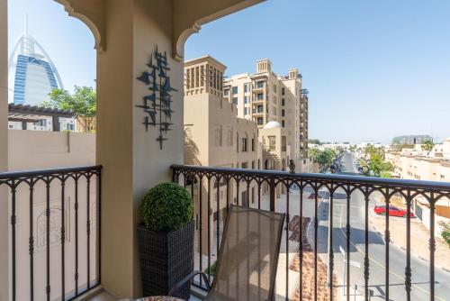 a balcony with a view of a city at Ultimate Stay / Burj Al Arab View / Brand New / Amazing Pool with a View / Perfect Holiday / Madinat Jumeirah / 2 BDR in Dubai