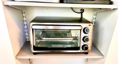 a toaster oven sitting on top of a shelf at Upgraded, Stylish & Comfy 1 Bedroom/1 Bath Studio in Payson