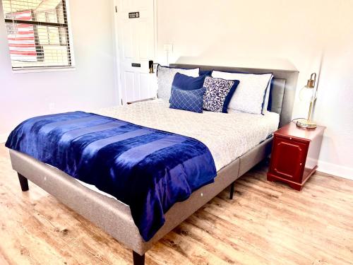 a bed with blue and white sheets and a night stand at Upgraded, Stylish & Comfy 1 Bedroom/1 Bath Studio in Payson