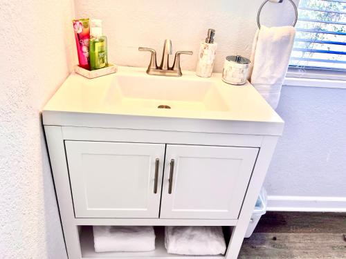 a white bathroom sink sitting next to a wall at Upgraded, Stylish & Comfy 1 Bedroom/1 Bath Studio in Payson