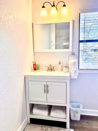 a bathroom with a white sink and a mirror at Upgraded, Stylish & Comfy 1 Bedroom/1 Bath Studio in Payson