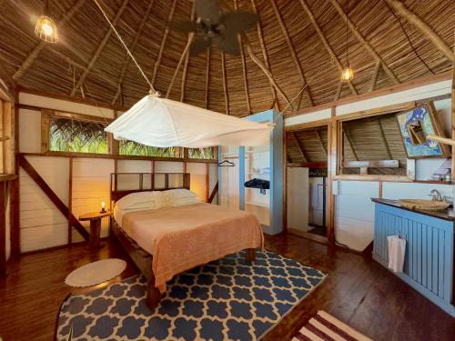 a bedroom with a bed and a ceiling at Casa Cayuco Eco-Adventure Lodge in Bocas del Toro