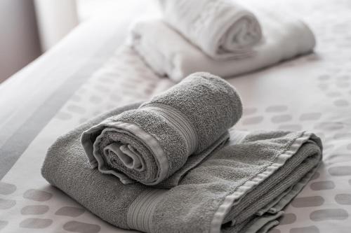 a couple of towels sitting on top of a bed at Vivienda Turística Portal de Teruel in Teruel