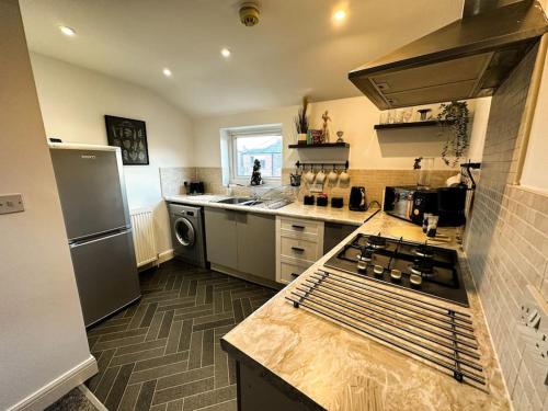 a kitchen with a sink and a stove top oven at Entire home/free parking /racecourse in York