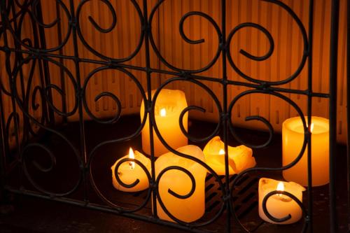 a group of candles behind a iron fence at VinsLounge Suite in Barletta