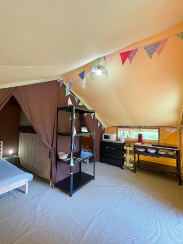 a room with a tent with bunk beds at Tente Lodge Bouleau - La Téouleyre in Saint-Julien-en-Born