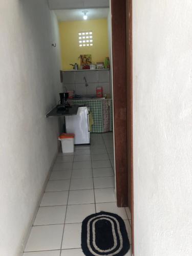 uma pequena cozinha com lavatório e piso em azulejo em Betesda 2197E KITNET em São Luís