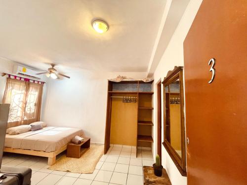 a small room with a bed and a closet at Anana Coliving in Playa del Carmen