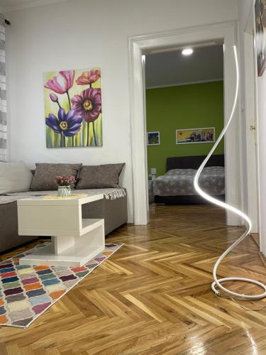 a living room with a couch and a table at IGNIM 2 Apartment in Subotica