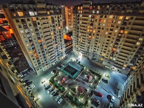 an aerial view of a parking lot with tall buildings at Private cozy room next to metro Garayev in Baku