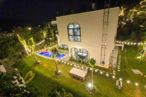 an aerial view of a house with lights in the yard at Venus An Khang's villa F2-15 in Vĩnh Phúc
