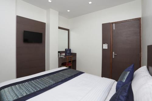 Łóżko lub łóżka w pokoju w obiekcie OYO Hotel Sun Palace
