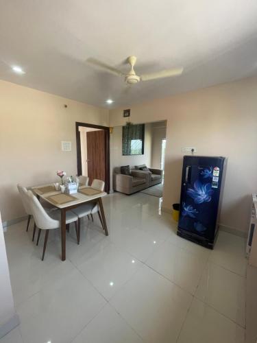 a living room with a dining table and a tv at Reef Terrace Unit in Hyderabad