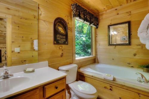 a bathroom with a tub and a toilet and a sink at A Secluded Bearadise #247 in Sevierville
