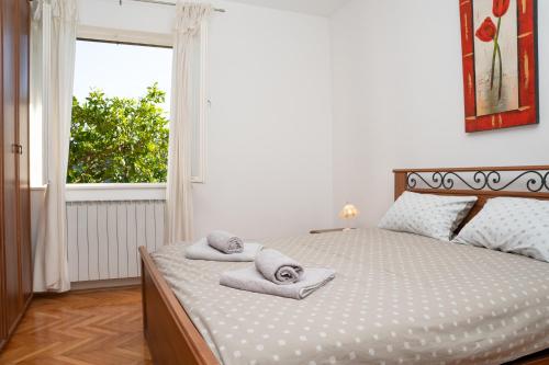 ein Schlafzimmer mit einem Bett mit Handtüchern darauf in der Unterkunft Apartment Stella Marina in Rabac