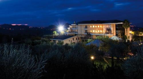a building with a light on top of it at night at Albergo Ristorante Uliveto in Veroli