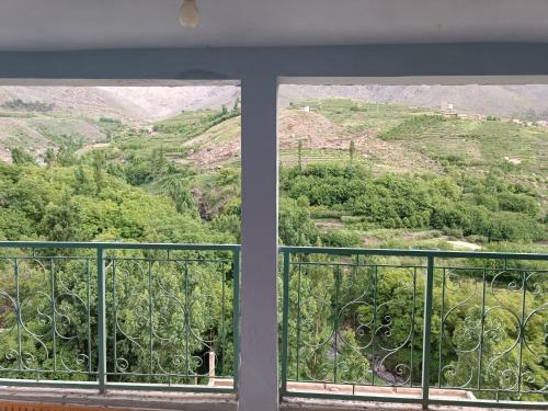 a window with a view of a mountain view at Riad Dar Amgdoule Tacheddirt in Tacheddirt