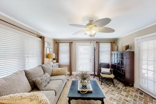a living room with a couch and a ceiling fan at Little River Waterway Cottage Retreat in Little River