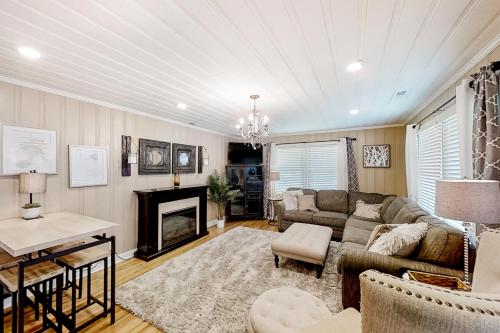 a living room with a couch and a fireplace at Little River Waterway Cottage Retreat in Little River