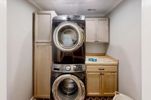 a washing machine and a dryer in a room at Little River Waterway Cottage Retreat in Little River