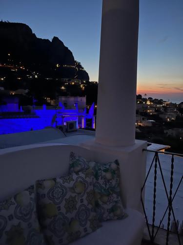 a pillow sitting on the ledge of a balcony at night at B&B L'Agapanto in Capri