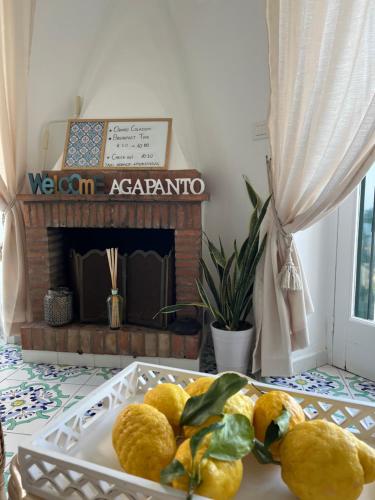 a plate of lemons on a table with a fireplace at B&B L'Agapanto in Capri