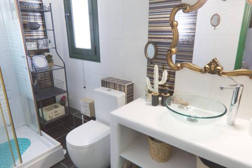 a bathroom with a toilet and a sink and a mirror at Sunset in Megalochori