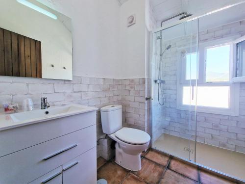 a bathroom with a toilet and a sink and a shower at EL BÚCARO. Las Puertitas Rojas in Ubrique