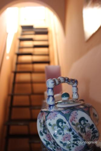 a vase sitting on a table next to a staircase at La Terrazza in Tuscania