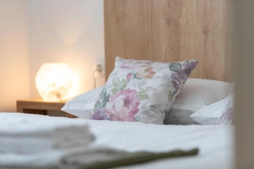 a bed with a pillow and a table with a lamp at Apartment Bellezza in Trogir
