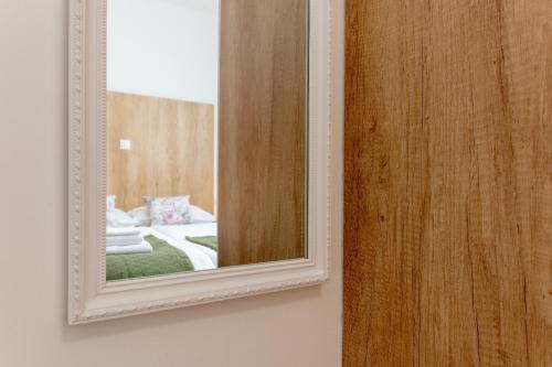 a mirror on a wall next to a room at Apartment Bellezza in Trogir
