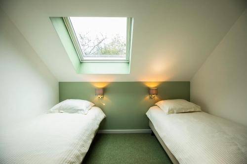 Postel nebo postele na pokoji v ubytování City Housing Genk
