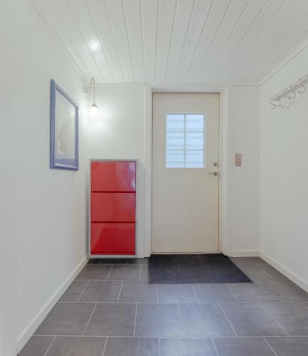 a room with a red door and a tile floor at Harbour View / 2BR / City Centre in Tórshavn