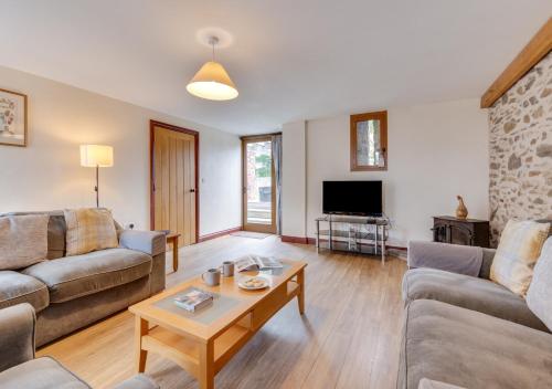 a living room with two couches and a coffee table at Canoldy in Builth Wells