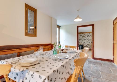 a dining room with a table with plates and glasses at Canoldy in Builth Wells