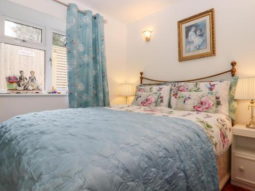 a bedroom with a bed with a blue comforter at Barons Mews in Herne Bay