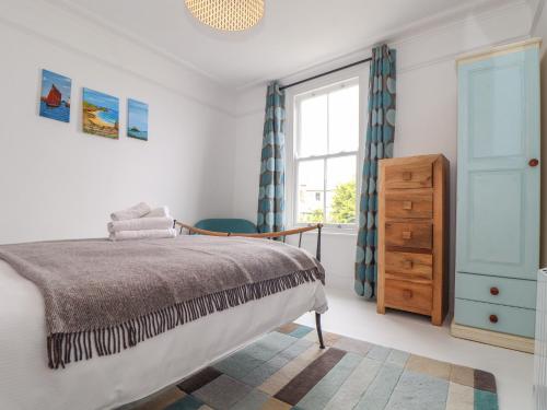 a bedroom with a bed and a window at Mermaid Cottage in Penzance