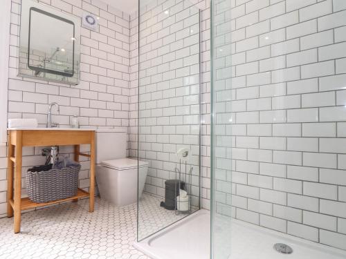 a bathroom with a shower and a sink and a toilet at Mermaid Cottage in Penzance