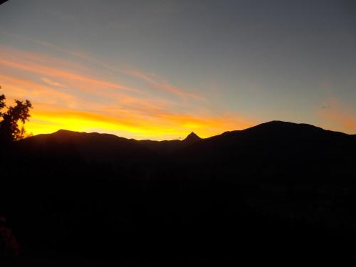 a sunset over a mountain range with a silhouette at Ferienhaus Hochwimmer in Hollersbach im Pinzgau