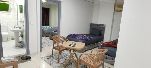 a living room with a couch and a table and chairs at Best Dreams Hotel in Cairo