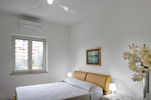 una camera bianca con un letto e una finestra di Caruso 2 - Sorrento a Sorrento
