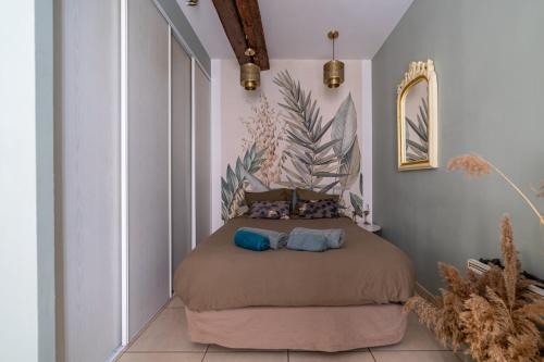 une chambre avec un lit avec deux oreillers dessus dans l'établissement L'écrin vert luxuriant - Halles & Cathédrale - Une Nuit à Nîmes, à Nîmes